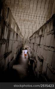 Caucasian young kid walking with labyrinth perspective. Conceptual image for dangerous situation during childhood.