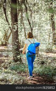 Caucasian young woman is walking in the wood, autumn