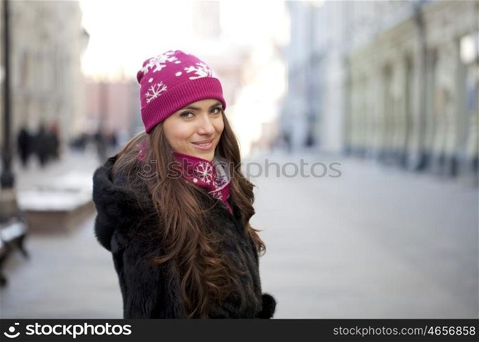 Caucasian young woman on a background of a winter city