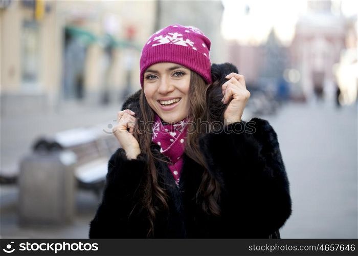 Caucasian young woman on a background of a winter city