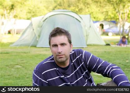 Caucassian man relaxed on the tent camping meadow