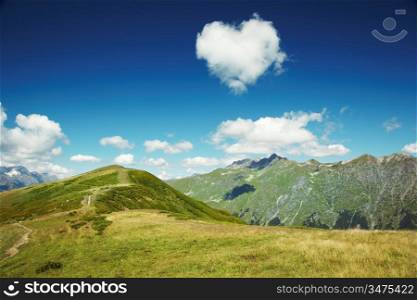 Caucasus mountains. Abkhazia. Heart from cloud in the blue sky