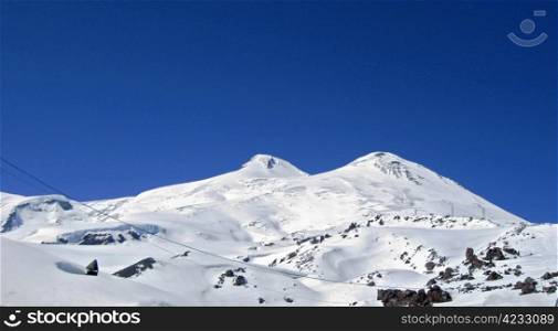 Caucasus mountains under the snow and clear sky. Elbrus