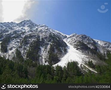 Caucasus mountains under the snow and cloudly sky
