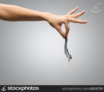 Caught businessman. Close up of human hand holding miniature of businessman