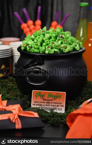 Cauldron green sweet popcorn for ghouls and zombies. Halloween treat