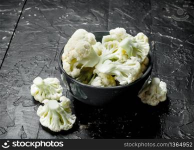 Cauliflower in bowl. On rustic background. Cauliflower in bowl.