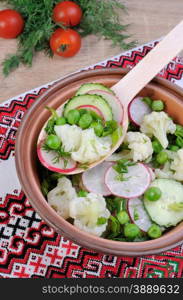 Cauliflower salad with cucumber, radish, peas and onions