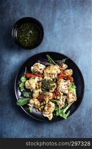 Cauliflower steamed with pine nuts, salad and pesto