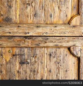 cavaria abstract rusty brass brown knocker in a door curch closed wood lombardy italy varese