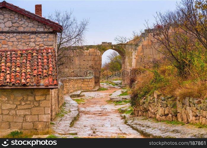 Cave city of Chufut-Kale in Crimea, view of the arch and the road