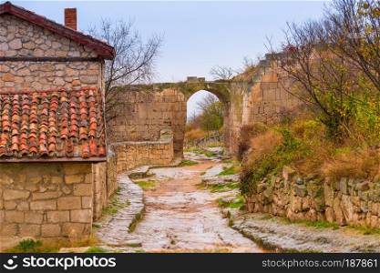 Cave city of Chufut-Kale in Crimea, view of the arch and the road