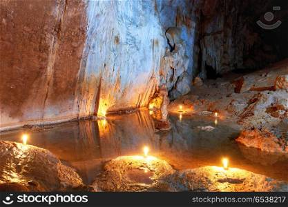 Cave dark interior with underground lake. Cave dark interior with underground lake, light, stalactites and stalagmites