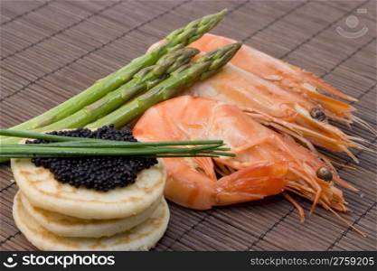caviar and shrimps. a finger food with shrimp, caviar and asparagus