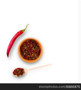 Cayenne pepper and Red peppers on plate and wooden spoon on white background