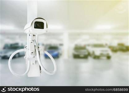 CCTV security camera with blurred car parking background