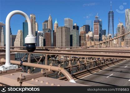 CCTV surveillance camera over the Traffic in morning rush hour before working day on the Brooklyn bridge over New York cityscape background, USA, United States, Business and transportation concept