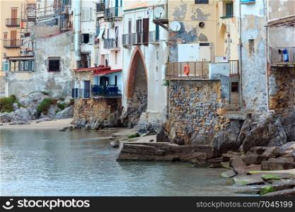 Cefalu old beautiful town houses above beach view, Palermo region, Sicily, Italy.