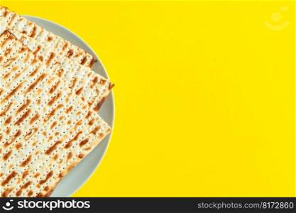 Celebrating the traditional Jewish holiday of Passover. Matzo on yellow background. Pesach matzah. Place for text.. Celebrating the traditional Jewish holiday of Passover. Matzo on a yellow background. Pesach matzah.