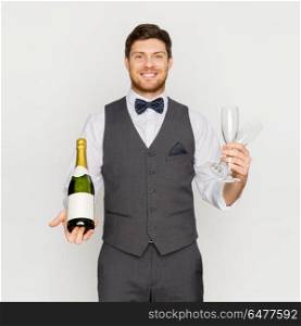 celebration, alcohol and holidays concept - happy man or waiter holding bottle of champagne and wine glasses at party. man with bottle of champagne and glasses at party. man with bottle of champagne and glasses at party