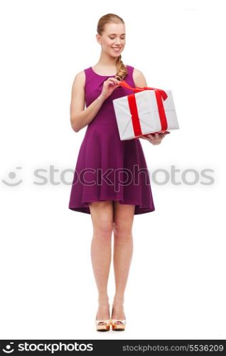 celebration and birthday concept - wondering smiling girl with present box