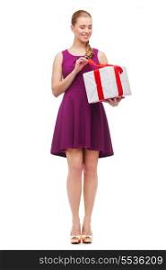 celebration and birthday concept - wondering smiling girl with present box