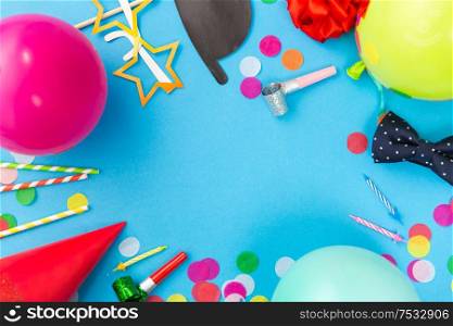 celebration and decoration concept - birthday party props, balloons and colorful confetti on blue background. birthday party props, balloons and confetti