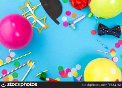 celebration and decoration concept - birthday party props, balloons and colorful confetti on blue background. birthday party props, balloons and confetti