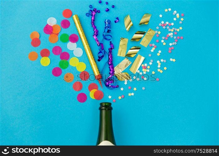 celebration and decoration concept - champagne bottle and birthday party props on blue background. champagne bottle with birthday party props on blue