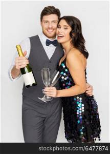 celebration and holidays concept - happy couple with bottle of non alcoholic champagne and wine glasses at party. happy couple with champagne and glasses at party. happy couple with champagne and glasses at party