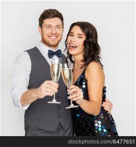 celebration and holidays concept - happy couple with glasses drinking non alcoholic champagne at party. happy couple with champagne glasses at party. happy couple with champagne glasses at party
