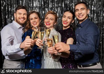 celebration and holidays concept - happy friends clinking champagne glasses at party. friends with champagne glasses at party