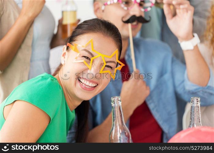 celebration and holidays concept - happy woman and friends with party accessories and non-alcoholic drinks having fun at home. happy woman with friends having fun at party
