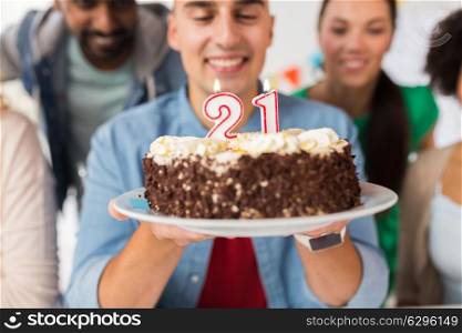 celebration and people concept - close up of happy friends greeting man with cake at twenty first birthday at party. man with cake and friends at birthday party