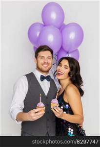 celebration, anniversary and holidays concept - happy couple with ultra violet balloons and cupcakes at birthday party. happy couple with balloons and cupcakes at party. happy couple with balloons and cupcakes at party