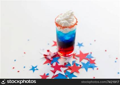 celebration, anniversary and national holidays concept - glass of layered cocktail drink with whipped cream cup at american independence day party. glass of drink on american independence day party