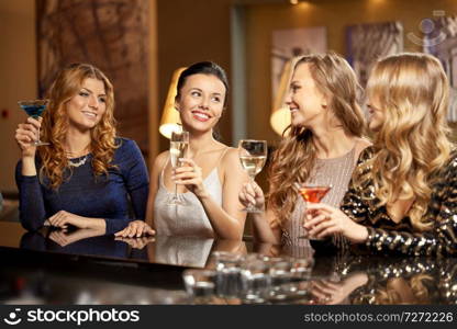 celebration, bachelorette party and holidays concept - happy women or female friends with non-alcoholic drinks in glasses at night club. happy women drinks in glasses at night club