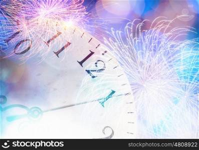 Celebration concept. Conceptual image of clock with bokeh lights and firework