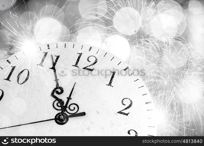 Celebration concept. Conceptual image of clock with bokeh lights and firework