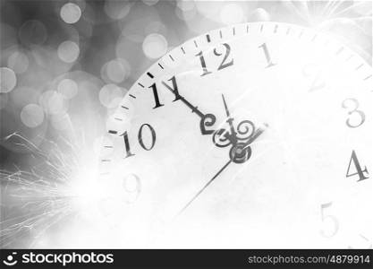 Celebration concept. Conceptual image of clock with bokeh lights and firework