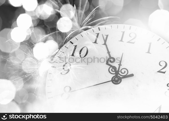 Celebration concept. Conceptual image of clock with bokeh lights and firework