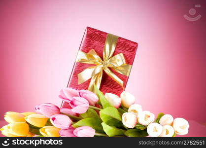 Celebration concept - gift box and tulip flowers