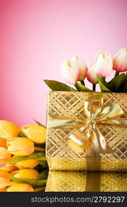 Celebration concept - gift box and tulip flowers