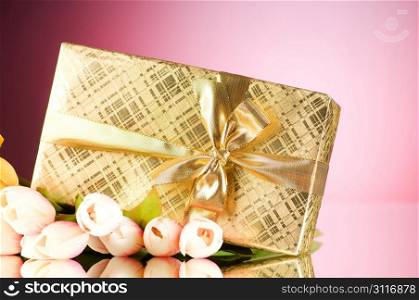 Celebration concept - gift box and tulip flowers