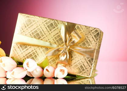 Celebration concept - gift box and tulip flowers