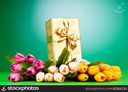 Celebration concept - gift box and tulip flowers