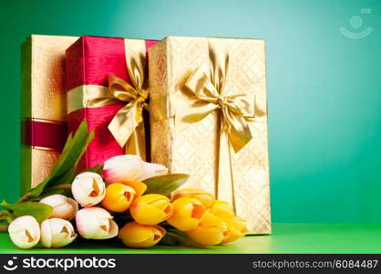 Celebration concept - gift box and tulip flowers