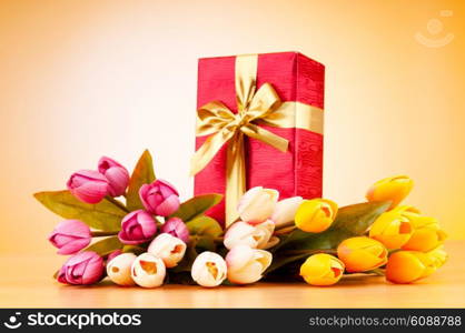 Celebration concept - gift box and tulip flowers