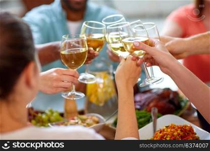 celebration, eating and holidays concept - hands clinking wine glasses. hands clinking wine glasses