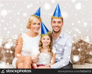 celebration, family, holidays and birthday concept - happy family in blue hats celebrating